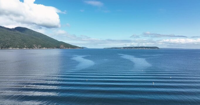 Aerial Drone Flying Toward Lummi Island Over Crabbing Buoys in Puget Sound Washington