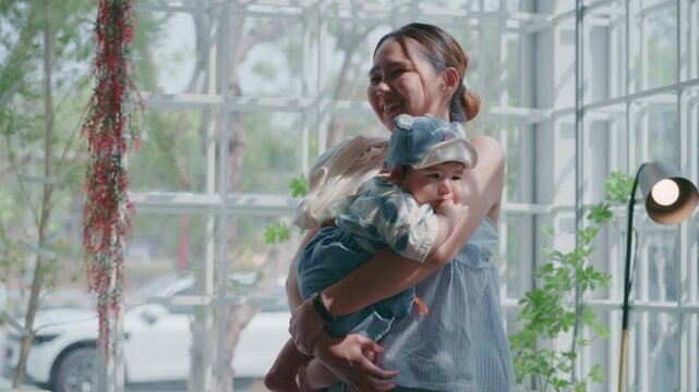 4K Beautiful lifestyle of an Asian mother holding her baby travel outdoor.