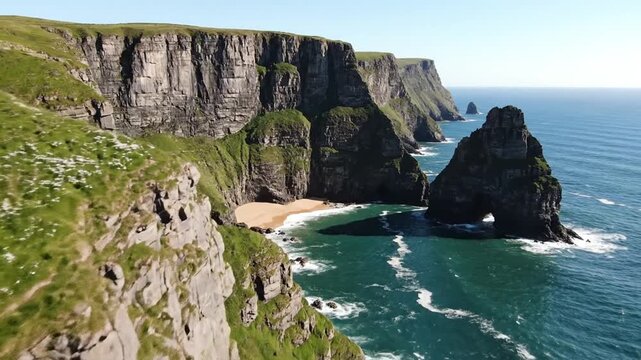 Aerial view of coastal cliffs meeting the sea, sunlit with blue water