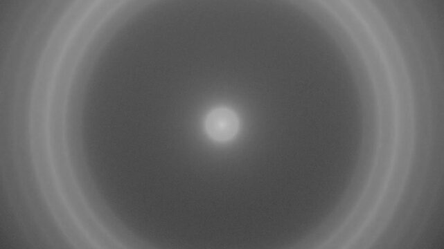 Concentric Gray Rings Expanding from Center Point