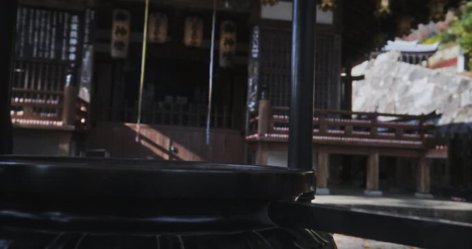 Majestic, old cauldron at ancient Japanese shrine - steady cam backwards movement