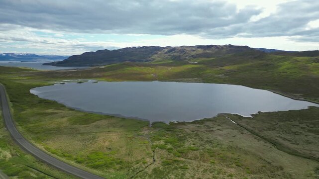 Secluded lake in remote Westfjords, flyover Icelandic landscape in midsummer - 4k