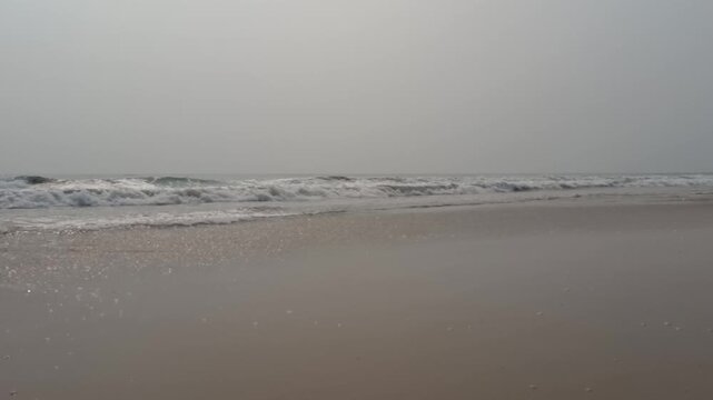 Side view of sea waves hitting the sea beach