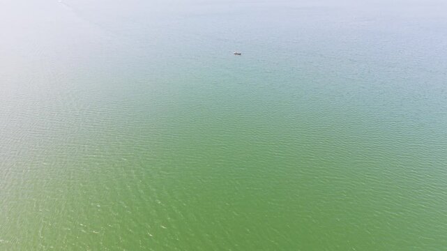 Aerial View Tilt of Small Boat in the Trị an Lake.