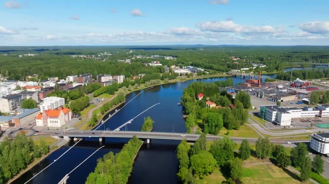 Aerial view following the Pielisjoki river, sunny, summer day in Joensuu, Finland