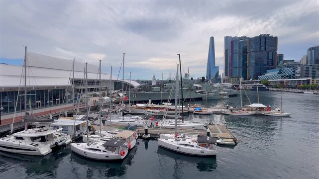 Boats and marina at Darling Harbour with HMAS Vampire and city buildings, Sydney, New South Wales, Australia.
