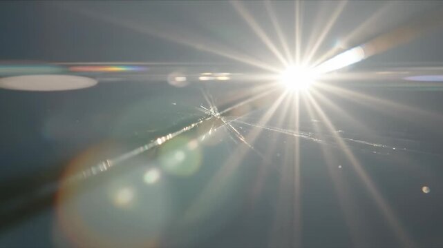 Shattered clock face with flying glass shards concept. Bright sunlight with lens flare and rays creating a glowing effect in the sky