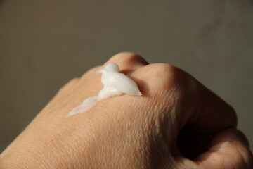 cream on a person's hand, large,