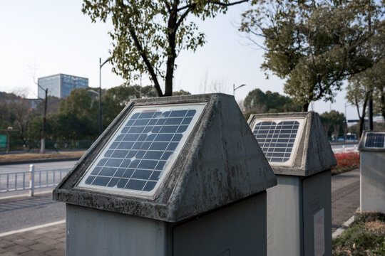 Solar-powered equipment installed along urban roadside in real-world setting