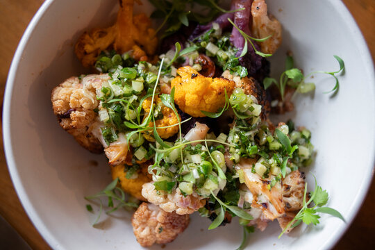 Close-up overhead of cauliflower dish with garnish