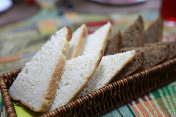 Sliced white and dark bread in wicker basket