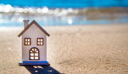 The symbol of the house standing on the seashore
