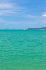 Obraz premium A beautiful view of Langkawi island against a beautiful blue sky with some boats in the distance on the horizon. Tropical scenery. located at Kedah, Malaysia - September 25 2024: