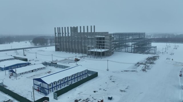 Concrete framework creates chaotic architectural mesh revealing industrial geometry. Construction stage exposes structural strength