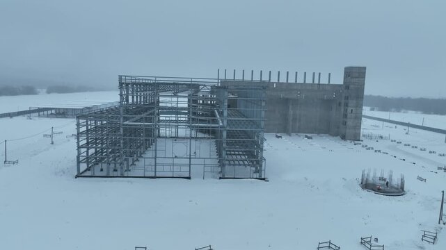 Winter building zone exposes repetitive concrete framework under snow. Harsh materials create disciplined functional visual structure
