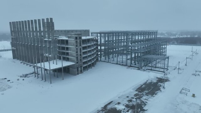Building under construction reveals complex interweaving concrete beams. Raw construction geometry forms dramatic industrial pattern