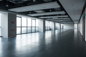 Fototapeta premium Modern office space with empty corridor and large floor-to-ceiling windows for natural lighting