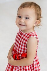 European one year baby model with curly hair and green eyes with happy face, beatiful smiling, first teeth celebrating christmas, birthday or happy easter