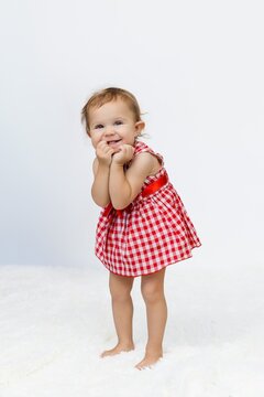 European one year baby model with curly hair and green eyes with happy face, beatiful smiling, first teeth celebrating christmas, birthday or happy easter