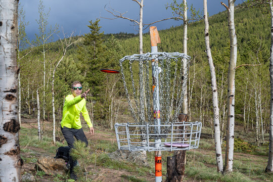 ale Disc Golfer Sinking a Putt on a Scenic Mountain Course