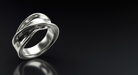 A close-up view of a silver ring with intricate designs on a black background