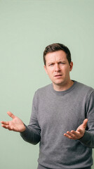 Confused Man Shrugging Shoulders With Questioning Expression