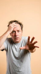Worried Middle Aged Man Reaching Out With Hand On Forehead