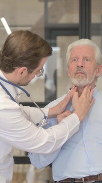 Doctor Checking Tonsils of Old Patient in Clinic, vertical video