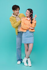 Romantic relationship lifestyle concept with Asian young couple smiling and interacting playfully expressing love emotional connection and modern casual fashion identity.