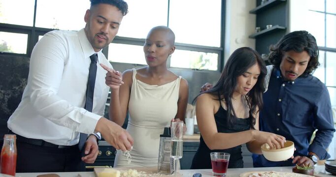 Diverse coworkers agreeing to make pizza slicing sprinkling cheese at kitchen counter with grater
