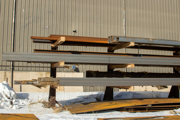 Steel stored on a rack at an industrial site during winter