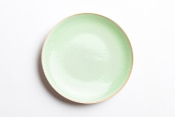 Top view of isolated of colored background empty round green plate for food. Empty dish with space for your design © sosiukin