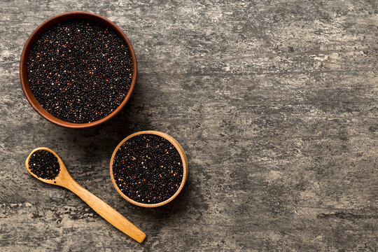 quinoa seeds in bowl and spoon on colored background. Healthy kinwa in small bowl. Healthy superfood