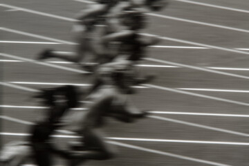 High-energy action shot of sprinters exploding from starting blocks on track. Authentic 35mm reversal film scan, motion blur effect, grainy analog sports photography. © Thierry Provost