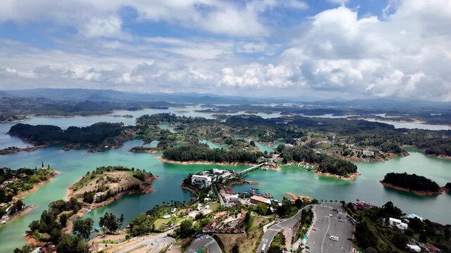 Vast emerald landscape, featuring the island-studded Guatape Reservoir and rolling Andean foothills, captured from the summit of El Pe&ntilde;ol, Colombia.