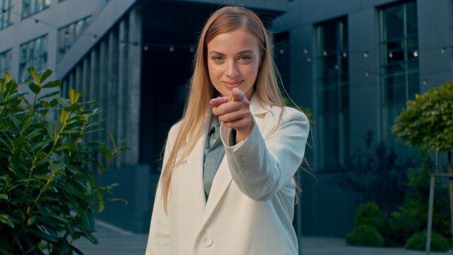 Smiling Caucasian business woman welcoming pointing at camera near office building hiring HR manager choosing candidate inviting gesture female businesswoman recruiter outdoor city corporate interview