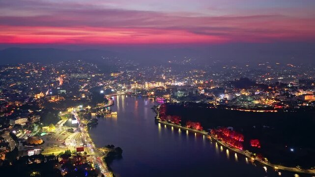 Aerial view Hyperlapse of Da Lat city, Vietnam at sunset and night with urban areas, markets, sparkling hotels, simple transportation system attracts tourists to visit on weekends