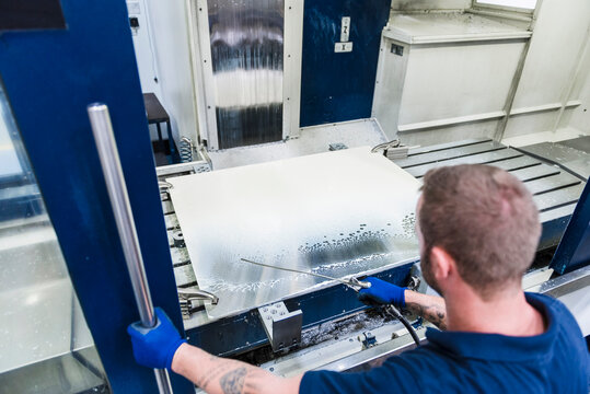 Man working on machine in industrial factory