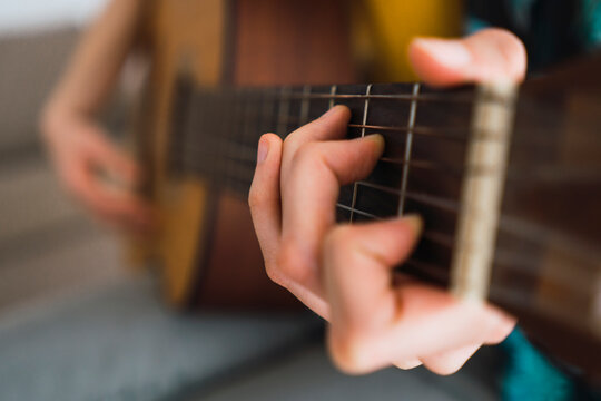 Close-up of woman playing guitar