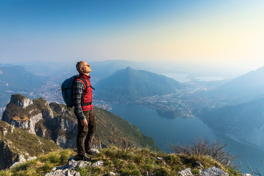Rear view of hiker on mountaintop, Orobie Alps, Lecco, Italy
