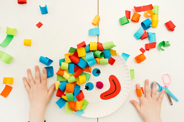 Paper plate clown. DIY games at home, activities for pre-school Kids. 5 minute crafts. Children joy and funny to cut a hair for clown. Red Nose Day theme.