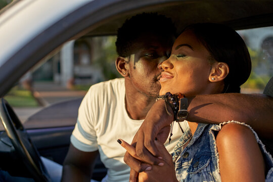 Young couple sitting car, kissing