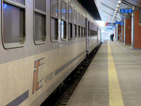 Krakow, Poland - December 3, 2025: PKP Intercity train waits at a modern train station platform with passengers preparing to board