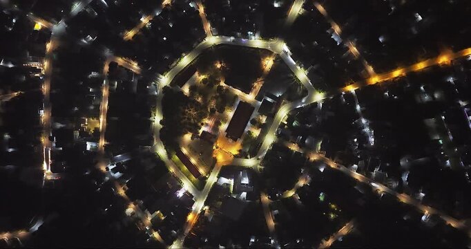 Aerial view of Residential area in Bao Loc city, Vietnam at night with the center being the church and the streets divided like abstract Chinese bagua