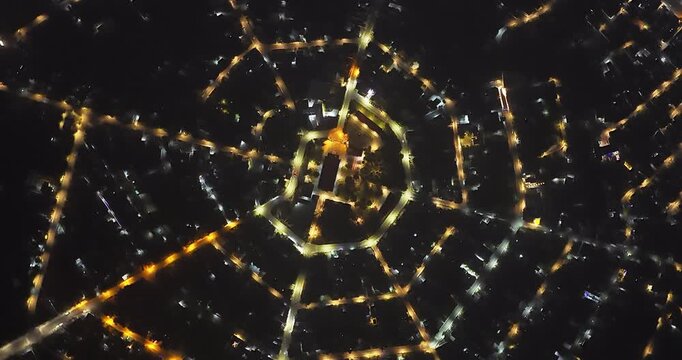 Aerial view of Residential area in Bao Loc city, Vietnam at night with the center being the church and the streets divided like abstract Chinese bagua