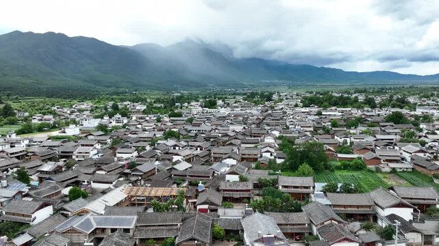 Baisha Ancient Town Aerial View with Mountain Backdrop