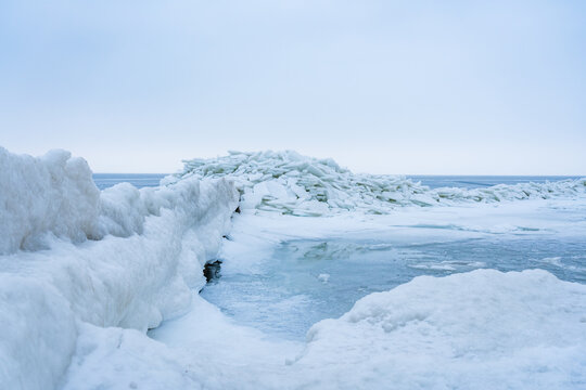 Stacked Ice Floes on the Baltic Coast of Usedom with Ice Covered Groynes