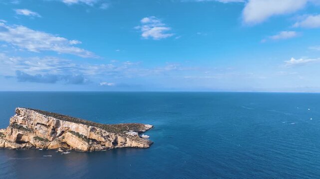 Flight close to famous Benidorm island and its steep limestone cliffs and gulls