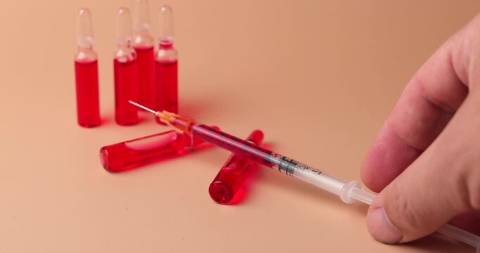 video of b12 injection Close up of B12 vials, red tablets and a medical form on cream gradient  background for professional healthcare and energy recovery