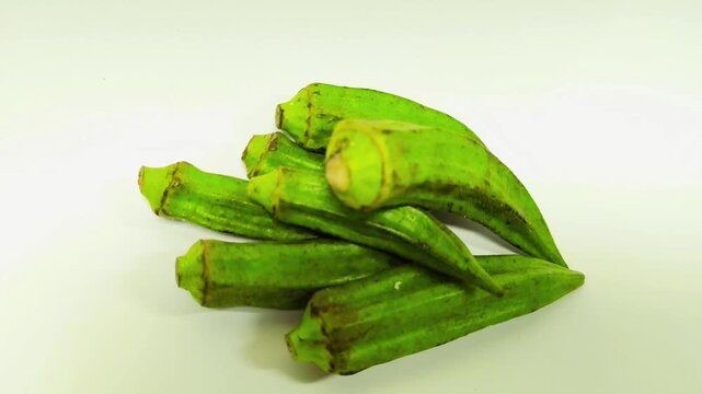 Organic okra, also known as lady's fingers or Gumbo, isolated on a white background. Close-up. Selective focus. Empty space.